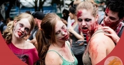 People dressed as zombies at a themed event with red overlay