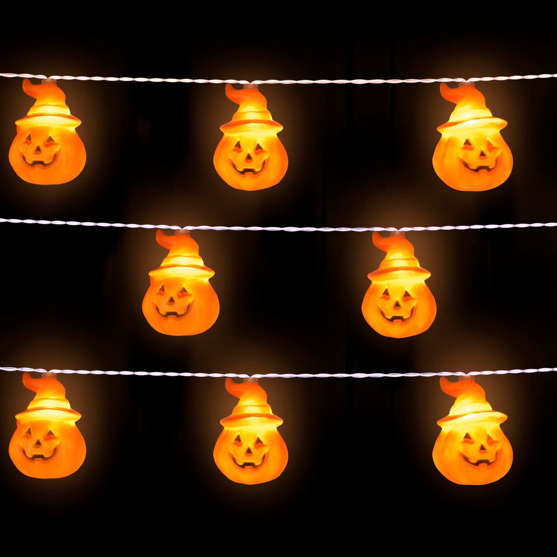 String of Halloween lights shaped like jack-o'-lanterns on a black background